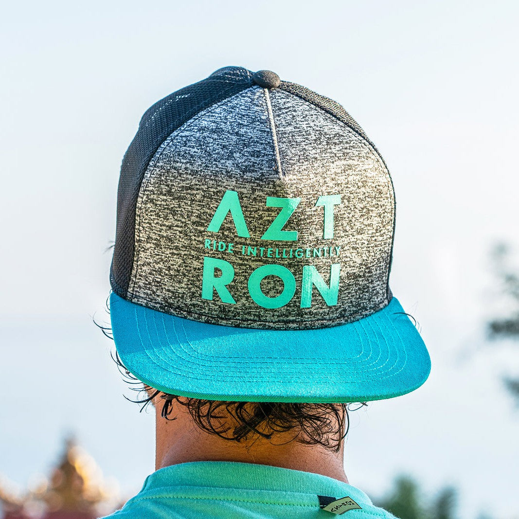 Hombre de espaldas con el jockey Aztron Full Logo gris y turquesa